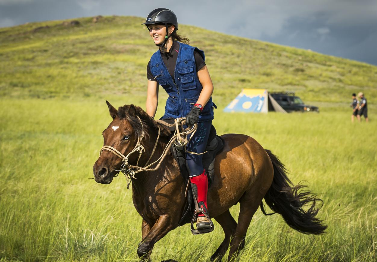 Lara Prior-Palmer riding a horse at the 2013 Mongol Derby